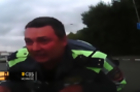 Watch: Russian Police Officer Clings to Hood of Car